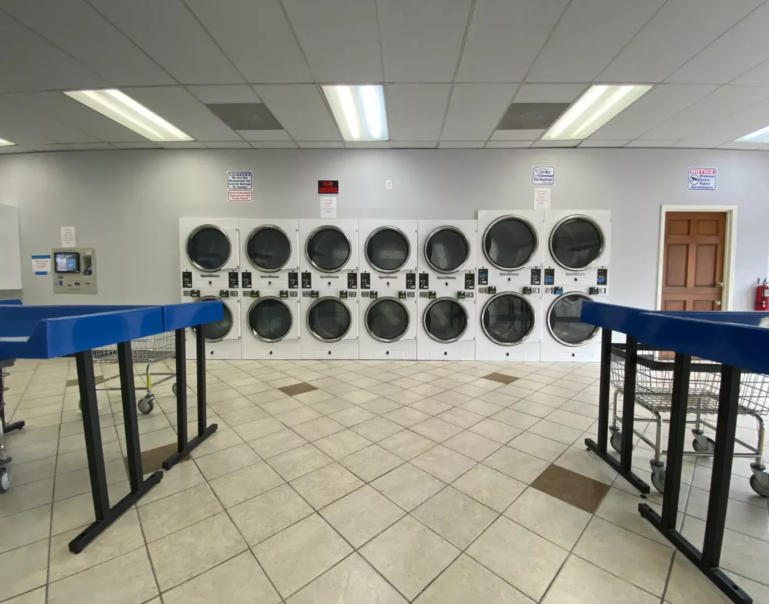 Wall of stacked dryers behind the folding tables